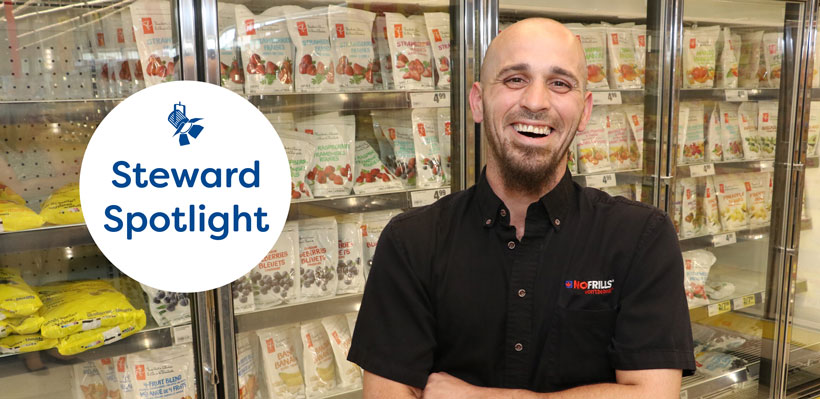 Union steward Matthew smiles standing in front of the freezers at the No Frills store where he works.