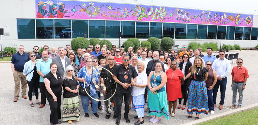 Union staff and activists gather in front of new Indigenous Mural installed at the Union Office. 